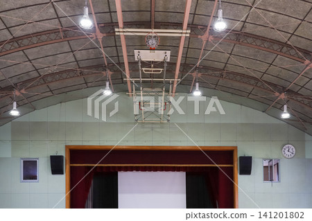 The stage and the basketball hoop on the ceiling of the school gymnasium The stage and the basketball hoop on the ceiling of the school gymnasium 141201802