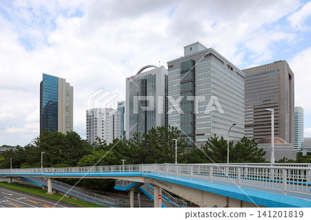 A cluster of skyscrapers and a large pedestrian bridge in the foreground. A cluster of skyscrapers and a large pedestrian bridge in the foreground. 141201819
