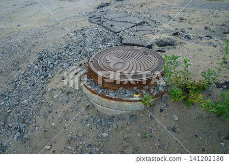 Manhole lifted by liquefaction 141202180