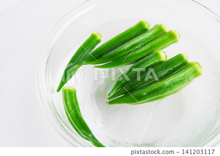 Boiled okra removed and placed in cold water 141203117