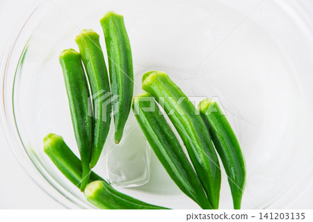 Boiled okra removed and placed in cold water Boiled okra removed and placed in cold water 141203135