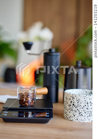 Coffee beans on scale before grinding Coffee beans on scale before grinding 141203219