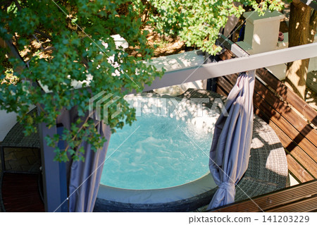 Inflatable Hot Tub with Bubbling Water on Outdoor Terrace Inflatable Hot Tub with Bubbling Water on Outdoor Terrace 141203229