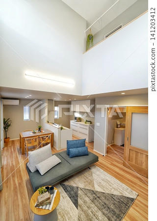 Living room with an open ceiling and stylish sofa Living room with an open ceiling and stylish sofa 141203412