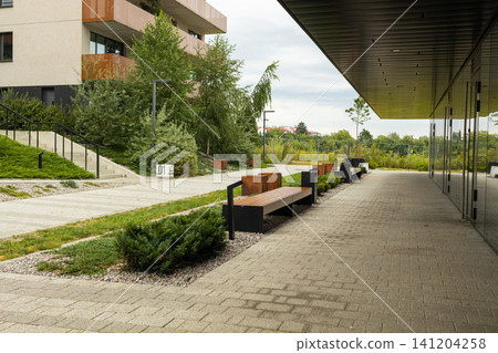 Modern apartment building with beautifully landscaped courtyard and paved pathway Modern apartment building with beautifully landscaped courtyard and paved pathway 141204258