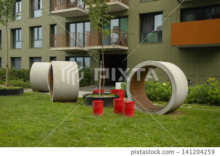 Modern residential building courtyard with contemporary concrete playground structures Modern residential building courtyard with contemporary concrete playground structures 141204259
