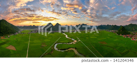 Aerial drone view panorama of Bac Son rice field valley at sunset, Lang Son, Vietnam Aerial drone view panorama of Bac Son rice field valley at sunset, Lang Son, Vietnam 141204346