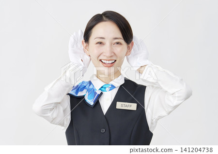 Female staff member, receptionist/bus guide, listening gesture, white background. Female staff member, receptionist/bus guide, listening gesture, white background. 141204738