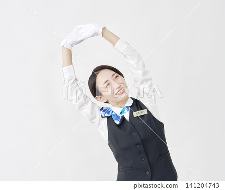Female staff member, receptionist/bus guide, stretching/relaxing, white background. Female staff member, receptionist/bus guide, stretching/relaxing, white background. 141204743