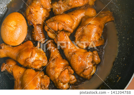 Teriyaki chicken drumsticks in a frying pan Teriyaki chicken drumsticks in a frying pan 141204788