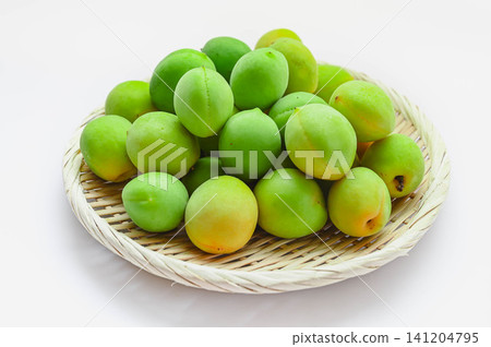Green plums served in a basket Green plums served in a basket 141204795
