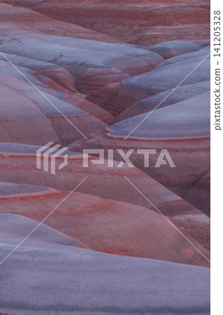 Beautiful serene landscape showing smooth layered sandstone formations with purple and red hues evoking peaceful feeling found in utah usa perfect for tranquil nature backgrounds and travel themes Beautiful serene landscape showing smooth layered sandstone formations with purple and red hues evoking peaceful feeling found in utah usa perfect for tranquil nature backgrounds and travel themes 141205328