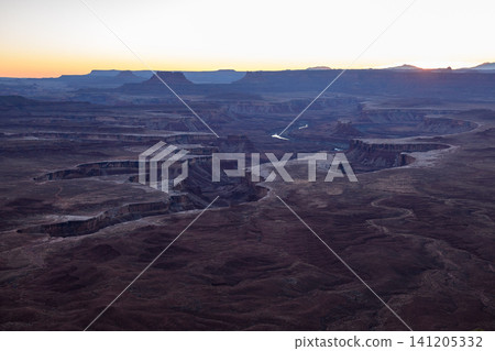 Peaceful majestic sunrise illuminates vast desert canyon valley landscape located in utah usa with stunning geological rock formation creating serene natural outdoor scenery for exploration Peaceful majestic sunrise illuminates vast desert canyon valley landscape located in utah usa with stunning geological rock formation creating serene natural outdoor scenery for exploration 141205332