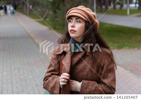 Portrait of beautiful woman strolls through quiet streets on a fall day, reflecting on her emotions during a solo city walk. Portrait of beautiful woman strolls through quiet streets on a fall day, reflecting on her emotions during a solo city walk. 141205407
