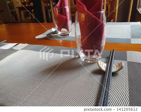 Chinese restaurant empty dinner placement with napkins and chopsticks Chinese restaurant empty dinner placement with napkins and chopsticks 141205612