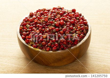 red pepper seeds in wooden plate red pepper seeds in wooden plate 141205750