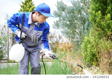 Pest control staff spraying pesticides on plants. Pest control staff spraying pesticides on plants. 141206032