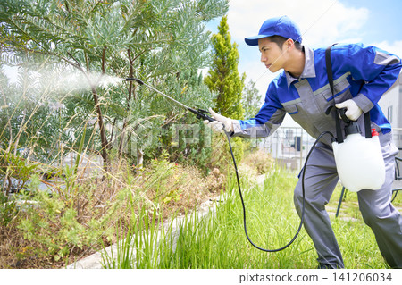 A young man working for a specialized company that sprays pesticides. A young man working for a specialized company that sprays pesticides. 141206034
