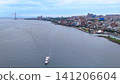 A magnificent panoramic view of a sightseeing boat gliding along the majestic Tamsui River and the Tamkang Bridge. A magnificent panoramic view of a sightseeing boat gliding along the majestic Tamsui River and the Tamkang Bridge. 141206604