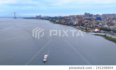 A magnificent panoramic view of a sightseeing boat gliding along the majestic Tamsui River and the Tamkang Bridge. A magnificent panoramic view of a sightseeing boat gliding along the majestic Tamsui River and the Tamkang Bridge. 141206604
