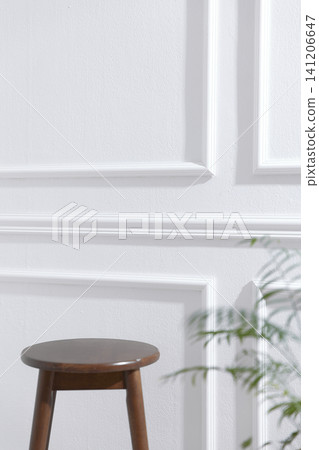 Elegant White Wainscoting Wall Background with Natural Sunlight and Green Plant 141206647