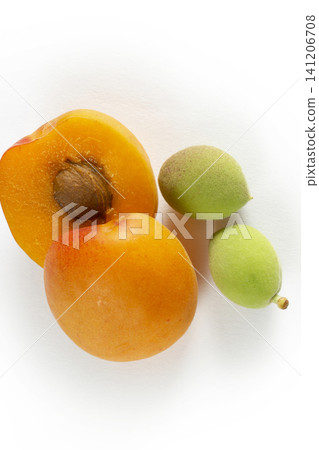 Green fresh apricots and ripe apricots on a white background Green fresh apricots and ripe apricots on a white background 141206708