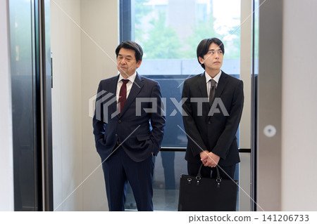 Awkward businessman in an elevator Awkward businessman in an elevator 141206733