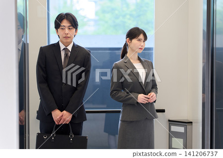 Awkward businessman in an elevator 141206737