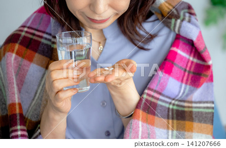 Woman taking medicine Woman taking medicine 141207666