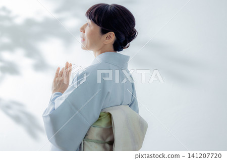A woman in a kimono A woman in a kimono 141207720