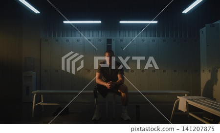 Amputee Athlete Mentally Preparing for Training in Modern Locker Room Amputee Athlete Mentally Preparing for Training in Modern Locker Room 141207875