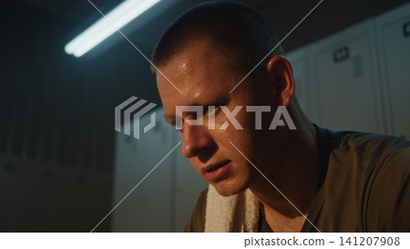 Sweaty Male Athlete Heavily Breathing in Locker Room 141207908
