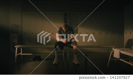 Resilient Man with Physical Disability Reflecting in Locker Room Resilient Man with Physical Disability Reflecting in Locker Room 141207927