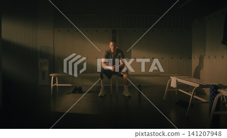 Resilient Man with Physical Disability Reflecting in Locker Room Resilient Man with Physical Disability Reflecting in Locker Room 141207948