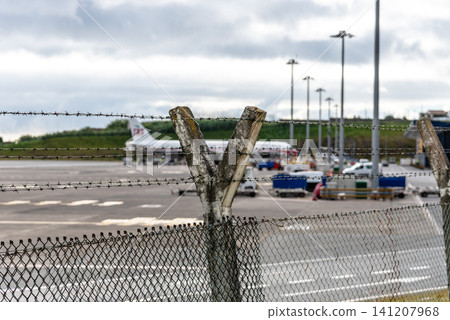 Airport Fence and Airplane Airport Fence and Airplane 141207968