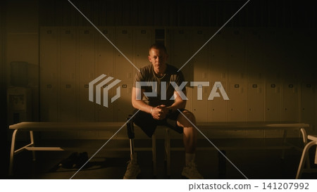 Determined Male Athlete with Prosthetic Leg Practicing Mindfulness Before Training Determined Male Athlete with Prosthetic Leg Practicing Mindfulness Before Training 141207992