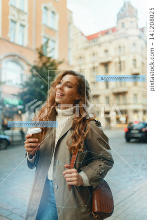 Woman holding coffee cup with facial recognition technology in a city setting Woman holding coffee cup with facial recognition technology in a city setting 141208025