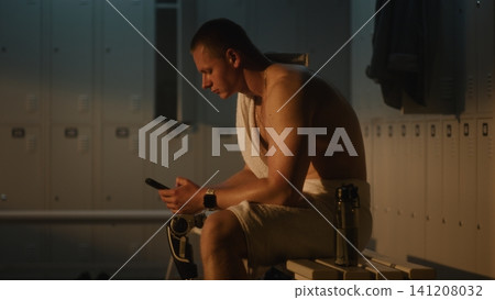 Resilient Man with Leg Prosthesis Checking Phone in Sunlit Dressing Room Resilient Man with Leg Prosthesis Checking Phone in Sunlit Dressing Room 141208032