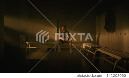 Amputee Athlete Finding Inner Strength and Focus in Sunlit Locker Room Amputee Athlete Finding Inner Strength and Focus in Sunlit Locker Room 141208060