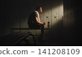 Exhausted Amputee Athlete Recovering in Locker Room After Training Session 141208109