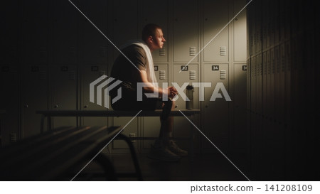 Exhausted Amputee Athlete Recovering in Locker Room After Training Session Exhausted Amputee Athlete Recovering in Locker Room After Training Session 141208109