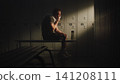 Exhausted Amputee Athlete Recovering in Locker Room After Training Session 141208111