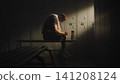 Exhausted Amputee Athlete Recovering in Locker Room After Training Session 141208124