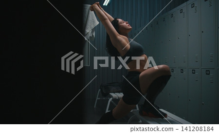 Female Athlete Doing Deep Lunges for Hip Mobility in Gym Locker Room Female Athlete Doing Deep Lunges for Hip Mobility in Gym Locker Room 141208184