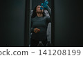 Sporty Female Changing Clothes and Drinking Water in Gym 141208199