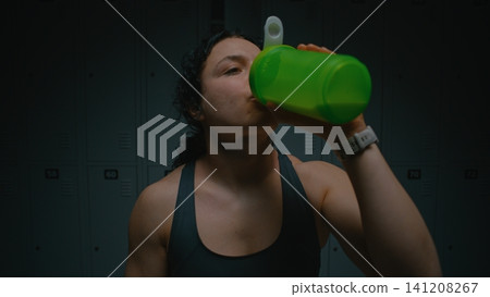Tired But Satisfied Female Sits on Bench after Intense Workout Tired But Satisfied Female Sits on Bench after Intense Workout 141208267