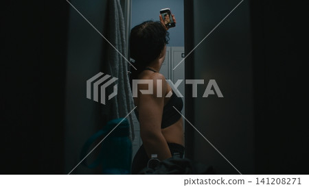 Confident Young Female Athlete Opening Door, Taking Smartphone, Posing For Selfie by Flexing Biceps Confident Young Female Athlete Opening Door, Taking Smartphone, Posing For Selfie by Flexing Biceps 141208271