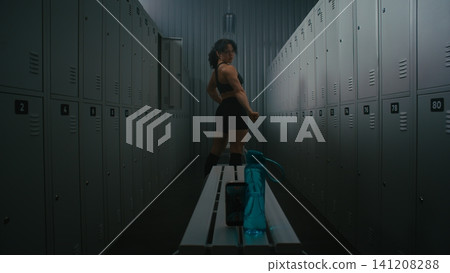 Female Fitness Influencer Recording Video of Flexing Muscles in Locker Room Female Fitness Influencer Recording Video of Flexing Muscles in Locker Room 141208288