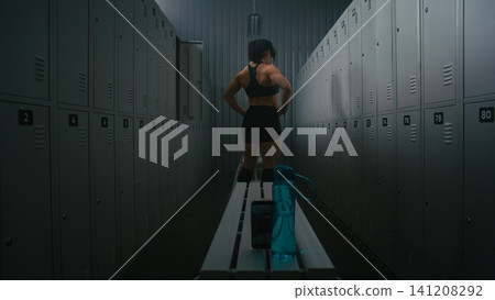 Female Fitness Influencer Recording Video of Flexing Muscles in Locker Room Female Fitness Influencer Recording Video of Flexing Muscles in Locker Room 141208292