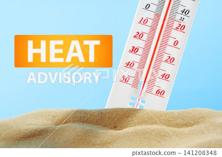 Heat advisory shows high temperature on thermometer with sand below indicating a heatwave situation Heat advisory shows high temperature on thermometer with sand below indicating a heatwave situation 141208348